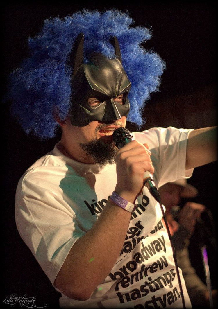 Doug Tree performing in his blue wig and Batman mask